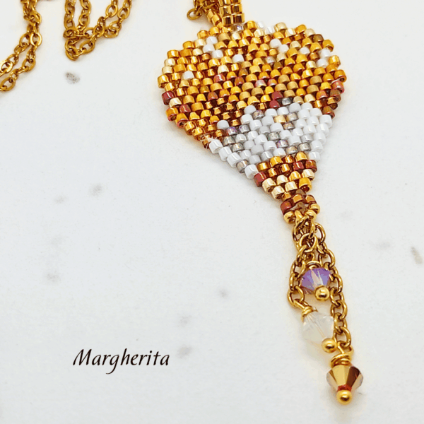 Collana a forma di mongolfiera "Margherita" firmata Vanitage Gioielli, realizzata a mano con perline di vetro sfumate oro, bianco e bronzo, dotata di catena dorata in acciaio e ciondolo a stella in argento 925 su sfondo chiaro