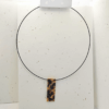 collana corta girocollo in stile animalier ghepardato, su sfondo chiaro