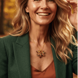 Collana fatta a mano con ciondolo a forma di foglia d'acero gialla e ocra, realizzata con un mosaico di perline di vetro tessuto a mano e completata da una catenina dorata. Indossata